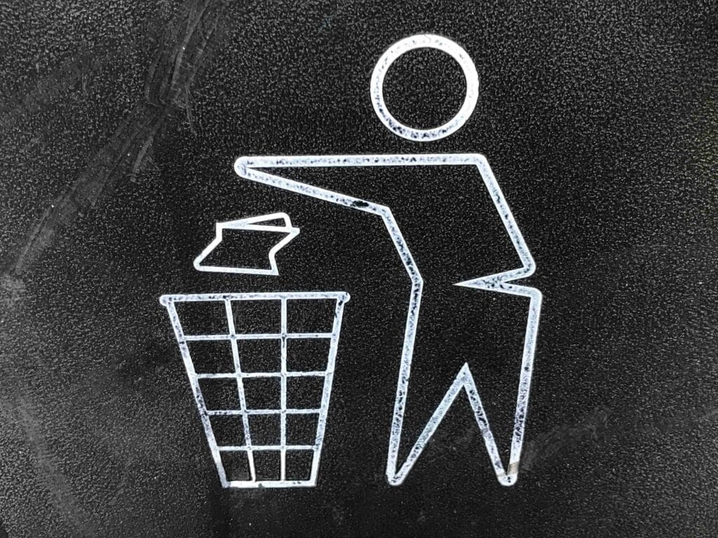 Icon of a person throwing trash into a bin – symbol for waste disposal and garbage bin rental management.